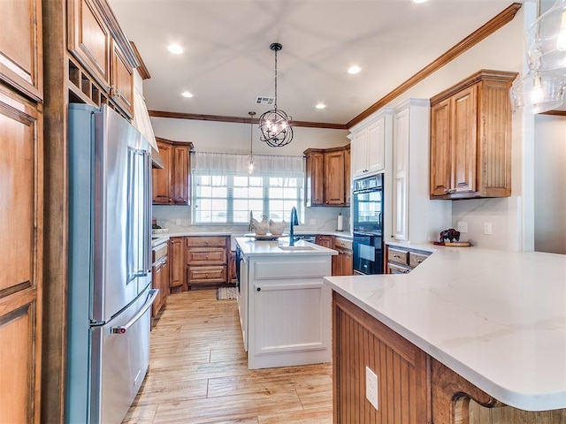 kitchen featuring high end refrigerator, crown molding, an island with sink, brown cabinets, and recessed lighting