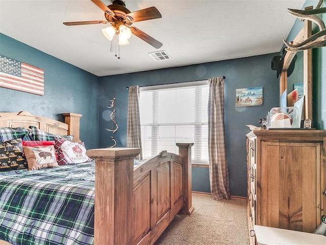 bedroom with light colored carpet, a ceiling fan, and baseboards