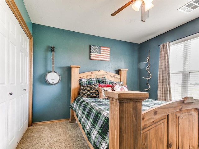 carpeted bedroom featuring baseboards, a closet, and a ceiling fan