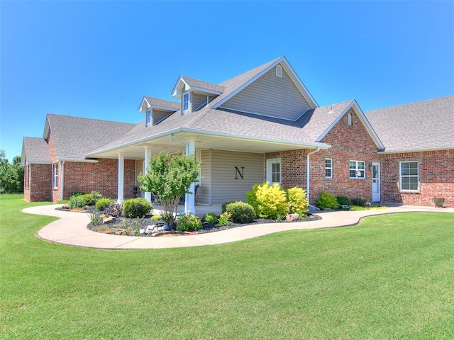 1486 County St Unit 2910 20, Acres Tuttle, OK 73089 - view of front of home featuring brick siding, a shingled roof, and a front lawn