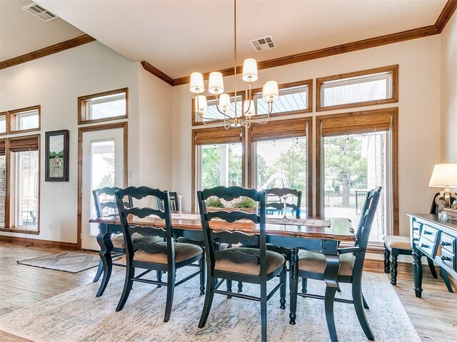 1486 County St Unit 2910 20, Acres Tuttle, OK 73089 - dining area featuring light wood-type flooring, ornamental molding, a chandelier, and baseboards