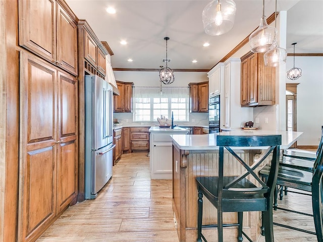 1486 County St Unit 2910 20, Acres Tuttle, OK 73089 - kitchen featuring high end refrigerator, ornamental molding, oven, brown cabinets, and light wood-style floors