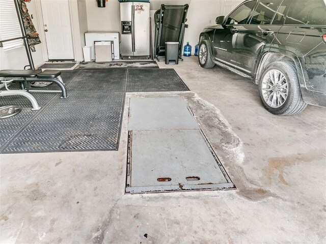 1486 County St Unit 2910 20, Acres Tuttle, OK 73089 - garage featuring stainless steel fridge with ice dispenser
