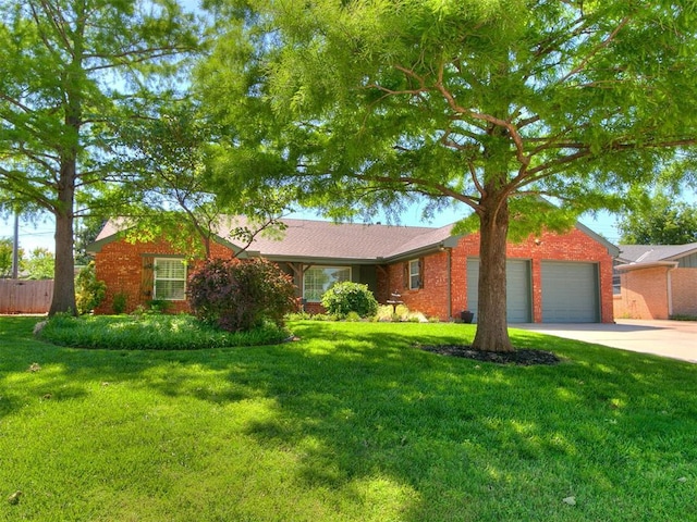 6709 Reed Dr, Oklahoma City, OK 73116 - ranch-style house with driveway, an attached garage, and brick siding