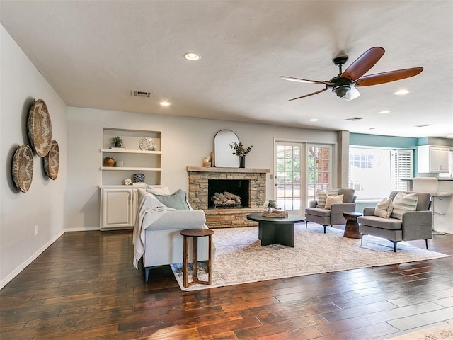 6709 Reed Dr, Oklahoma City, OK 73116 - living room with ceiling fan, dark wood-style floors, a stone fireplace, baseboards, and recessed lighting