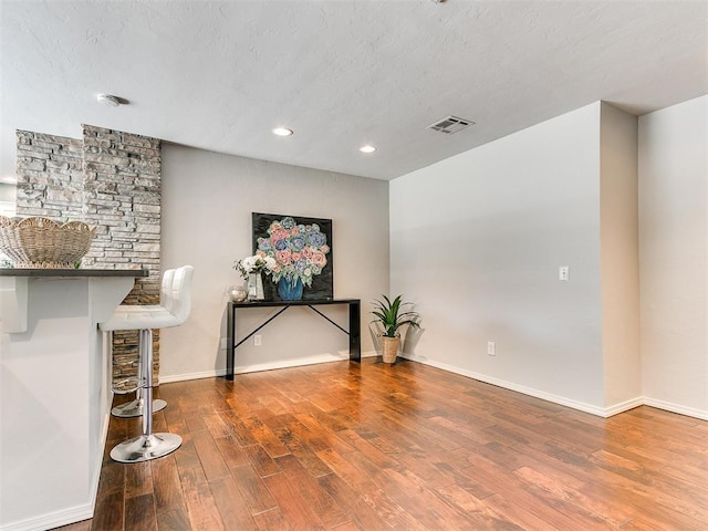 6709 Reed Dr, Oklahoma City, OK 73116 - unfurnished living room featuring wood finished floors, recessed lighting, baseboards, and a textured ceiling