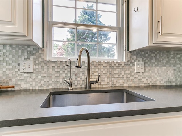 6709 Reed Dr, Oklahoma City, OK 73116 - kitchen view of a sink, dark countertops, and tasteful backsplash
