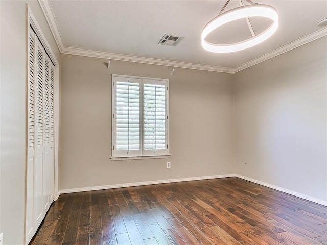 6709 Reed Dr, Oklahoma City, OK 73116 - unfurnished bedroom featuring hardwood / wood-style floors, a closet, baseboards, and crown molding