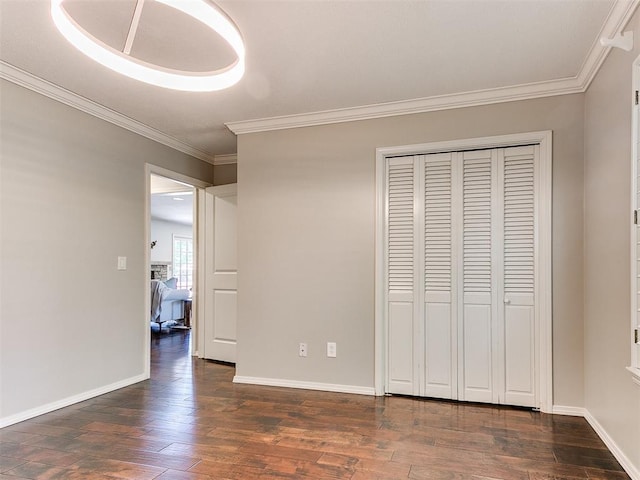 6709 Reed Dr, Oklahoma City, OK 73116 - unfurnished bedroom with crown molding, dark wood-style flooring, baseboards, and a closet