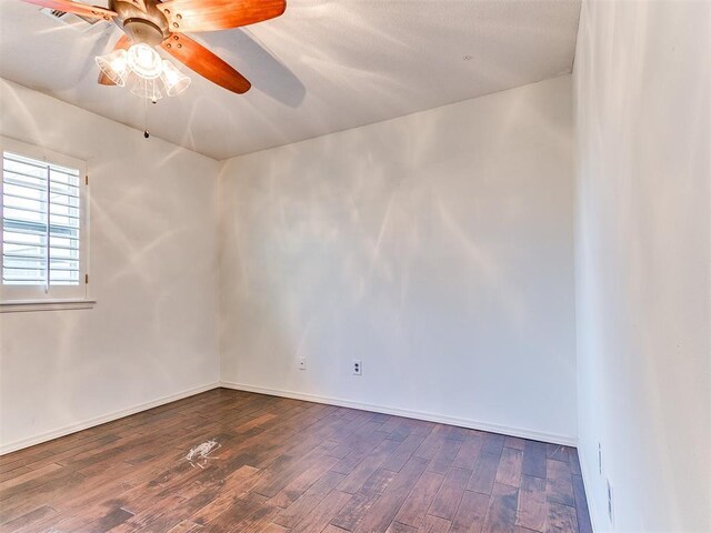 6709 Reed Dr, Oklahoma City, OK 73116 - spare room with dark wood finished floors, ceiling fan, and baseboards