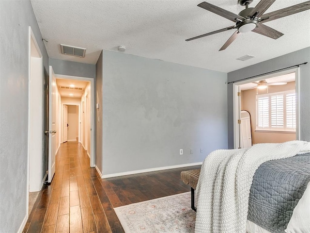 6709 Reed Dr, Oklahoma City, OK 73116 - bedroom featuring wood finished floors, a textured ceiling, baseboards, and a ceiling fan