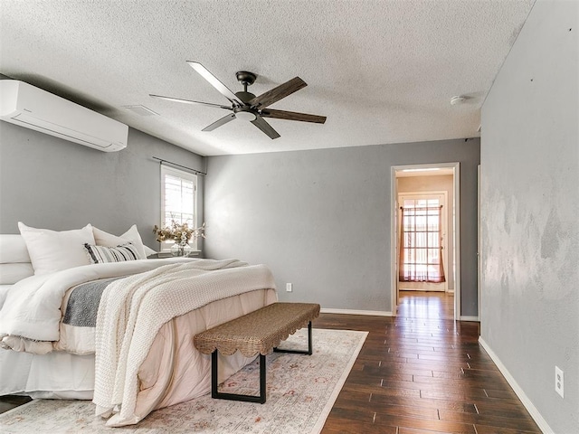 6709 Reed Dr, Oklahoma City, OK 73116 - bedroom with a wall mounted AC, a textured ceiling, dark wood finished floors, baseboards, and ceiling fan