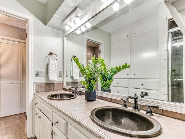 6709 Reed Dr, Oklahoma City, OK 73116 - bathroom with a closet and double vanity