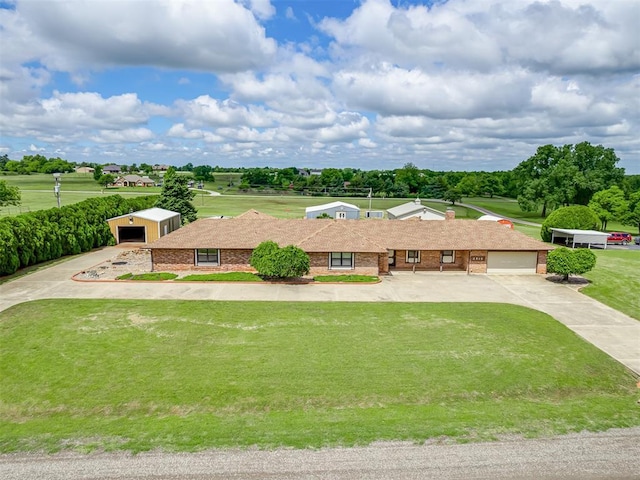 2915 N W Oaks Pl, Newcastle, OK 73065 - view of front of home featuring a front yard, brick siding, and driveway