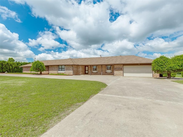 2915 N W Oaks Pl, Newcastle, OK 73065 - ranch-style house with brick siding, concrete driveway, an attached garage, and a front lawn