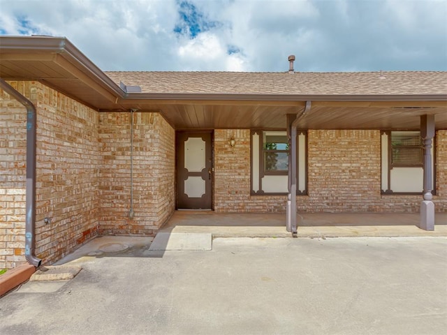 2915 N W Oaks Pl, Newcastle, OK 73065 - doorway to property with brick siding and a shingled roof
