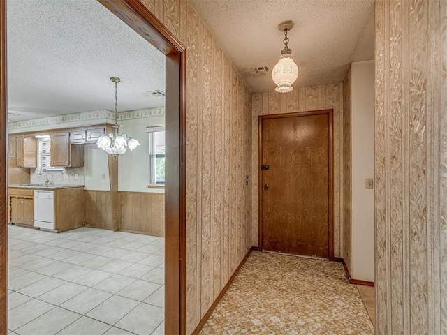 2915 N W Oaks Pl, Newcastle, OK 73065 - hall with a textured ceiling, a chandelier, and a sink