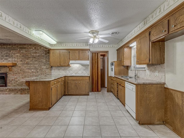 2915 N W Oaks Pl, Newcastle, OK 73065 - kitchen featuring dishwasher, a peninsula, under cabinet range hood, a sink, and ceiling fan