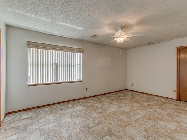 2915 N W Oaks Pl, Newcastle, OK 73065 - unfurnished room with ceiling fan, a textured ceiling, and baseboards