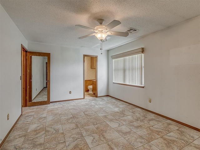 2915 N W Oaks Pl, Newcastle, OK 73065 - spare room featuring a textured ceiling, a ceiling fan, and baseboards