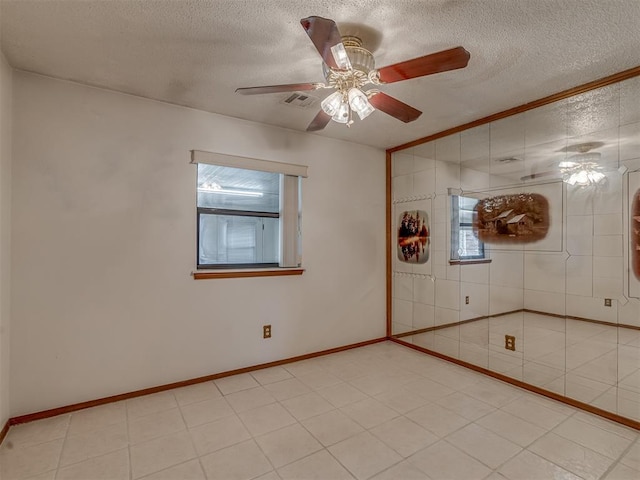 2915 N W Oaks Pl, Newcastle, OK 73065 - spare room with a textured ceiling, a ceiling fan, and baseboards