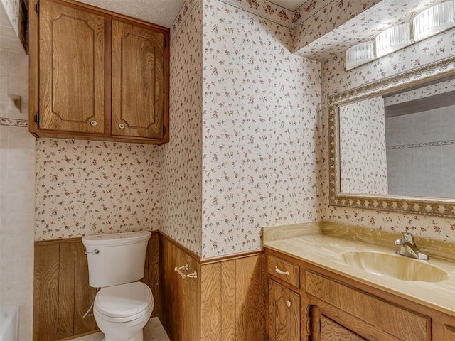 2915 N W Oaks Pl, Newcastle, OK 73065 - full bath featuring wallpapered walls, wainscoting, toilet, and vanity