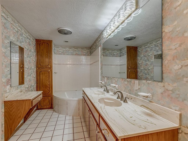 2915 N W Oaks Pl, Newcastle, OK 73065 - bathroom with a textured ceiling, a garden tub, wallpapered walls, tile patterned floors, and double vanity