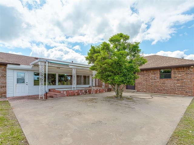 2915 N W Oaks Pl, Newcastle, OK 73065 - back of property with a patio, brick siding, and roof with shingles