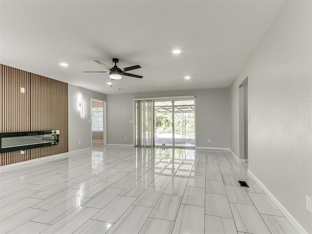 6501 N Laird Ave, Oklahoma City, OK 73105 - unfurnished living room with ceiling fan, baseboards, and recessed lighting