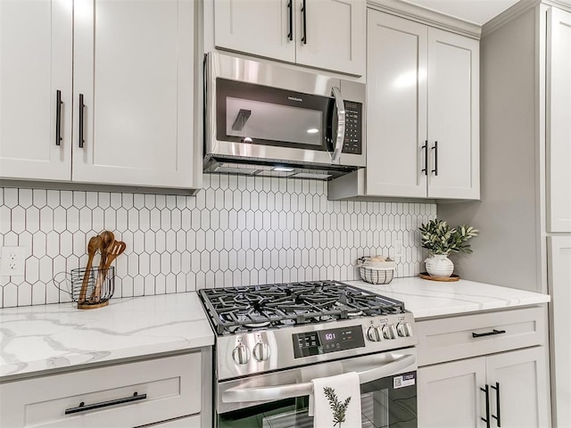 6501 N Laird Ave, Oklahoma City, OK 73105 - kitchen featuring appliances with stainless steel finishes, backsplash, and light stone counters