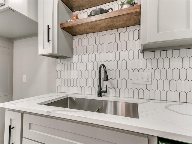 6501 N Laird Ave, Oklahoma City, OK 73105 - kitchen with decorative backsplash, a sink, open shelves, and light stone countertops