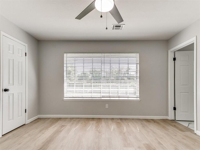 6501 N Laird Ave, Oklahoma City, OK 73105 - unfurnished bedroom with light wood-style flooring, multiple windows, and baseboards