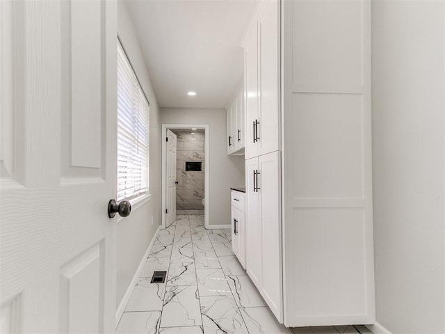 6501 N Laird Ave, Oklahoma City, OK 73105 - laundry area with light marble finish floors, baseboards, and recessed lighting