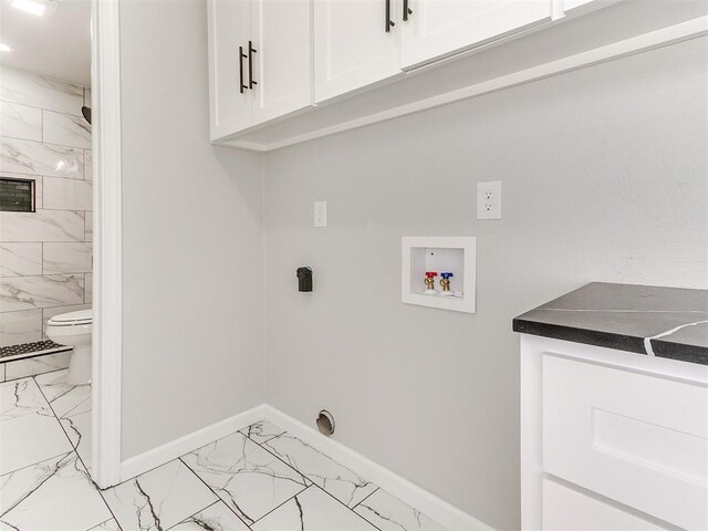 6501 N Laird Ave, Oklahoma City, OK 73105 - clothes washing area featuring light marble finish floors, cabinet space, hookup for a washing machine, and baseboards