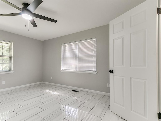 6501 N Laird Ave, Oklahoma City, OK 73105 - spare room featuring ceiling fan and baseboards