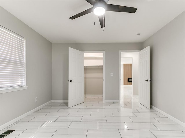 6501 N Laird Ave, Oklahoma City, OK 73105 - unfurnished bedroom with baseboards, a spacious closet, a ceiling fan, and a closet