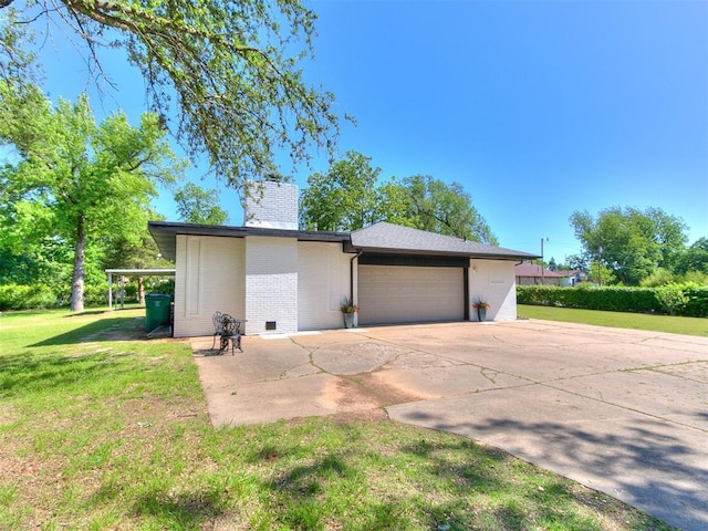 6501 N Laird Ave, Oklahoma City, OK 73105 - view of side of home with driveway, a chimney, a garage, a lawn, and brick siding