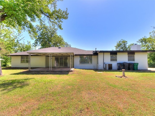 6501 N Laird Ave, Oklahoma City, OK 73105 - rear view of house with a chimney, a patio, a lawn, central air condition unit, and a carport