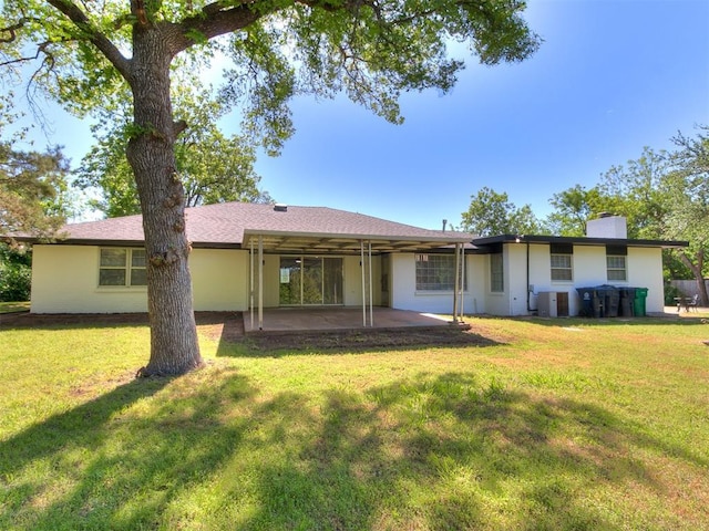 6501 N Laird Ave, Oklahoma City, OK 73105 - back of property featuring a patio area, a chimney, a yard, and a carport