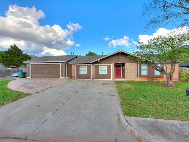 single story home with a garage, concrete driveway, and a front lawn
