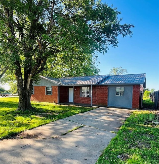 2217 7th St, Prague, OK 74864 - single story home with driveway, brick siding, and a front yard