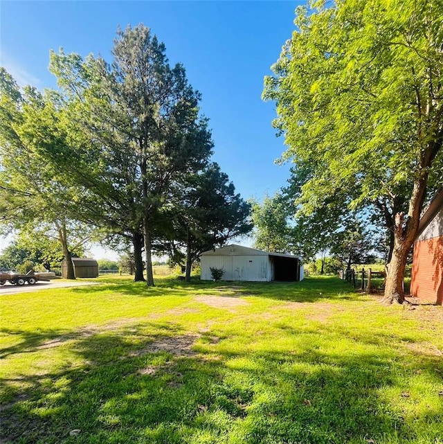 2217 7th St, Prague, OK 74864 - view of green lawn featuring a pole building and an outdoor structure