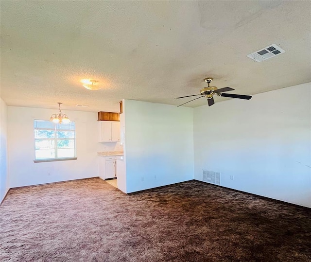 2217 7th St, Prague, OK 74864 - empty room with light colored carpet, a chandelier, a textured ceiling, a ceiling fan, and baseboards