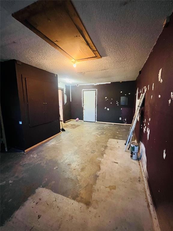 2217 7th St, Prague, OK 74864 - basement featuring a textured ceiling and a garage