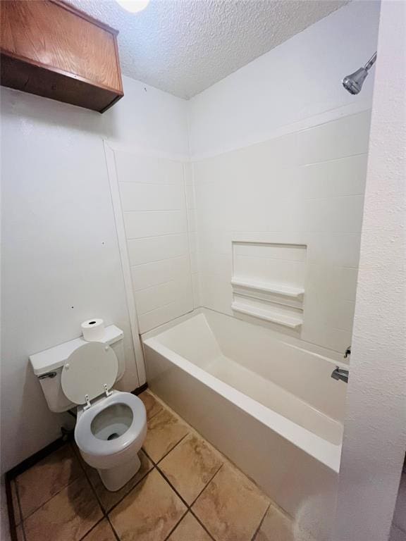 2217 7th St, Prague, OK 74864 - bathroom with a textured ceiling, tile patterned flooring, toilet, and bathtub / shower combination
