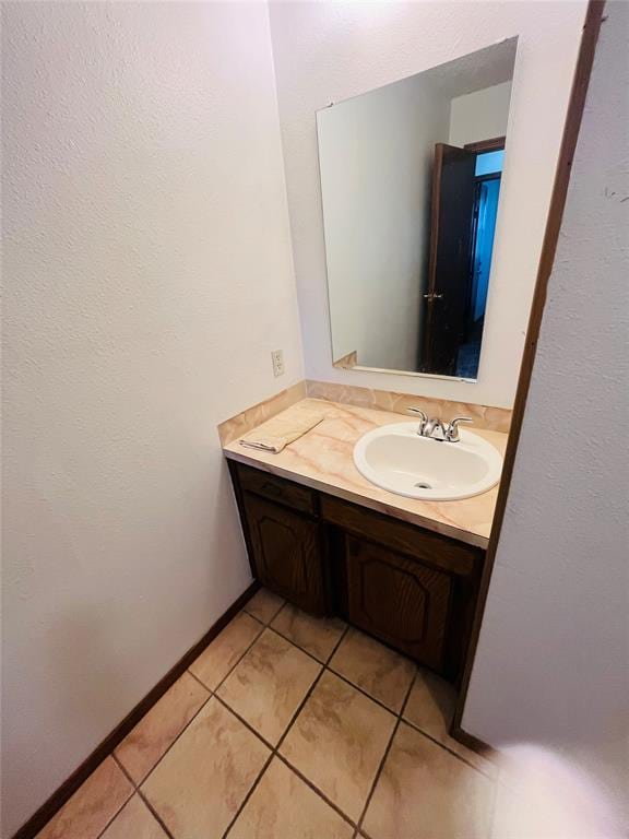 2217 7th St, Prague, OK 74864 - bathroom featuring tile patterned flooring, vanity, and baseboards