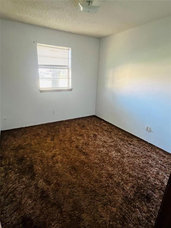2217 7th St, Prague, OK 74864 - spare room featuring carpet flooring and a textured ceiling
