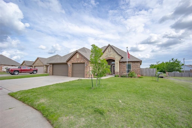 708 Carol Ann Pl, Moore, OK 73160 - french country inspired facade with an attached garage, concrete driveway, brick siding, and stone siding
