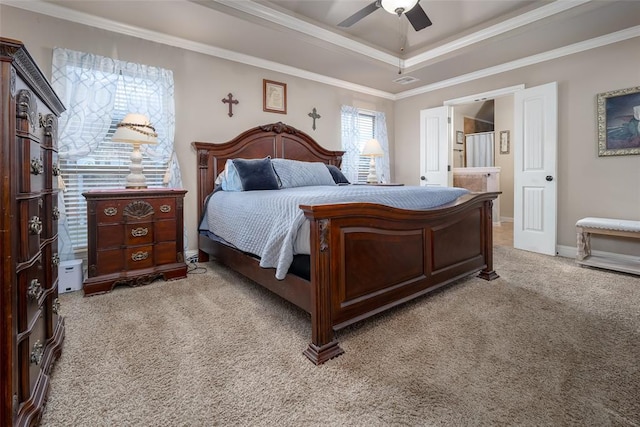 708 Carol Ann Pl, Moore, OK 73160 - bedroom featuring light colored carpet, a tray ceiling, crown molding, ensuite bath, and a ceiling fan