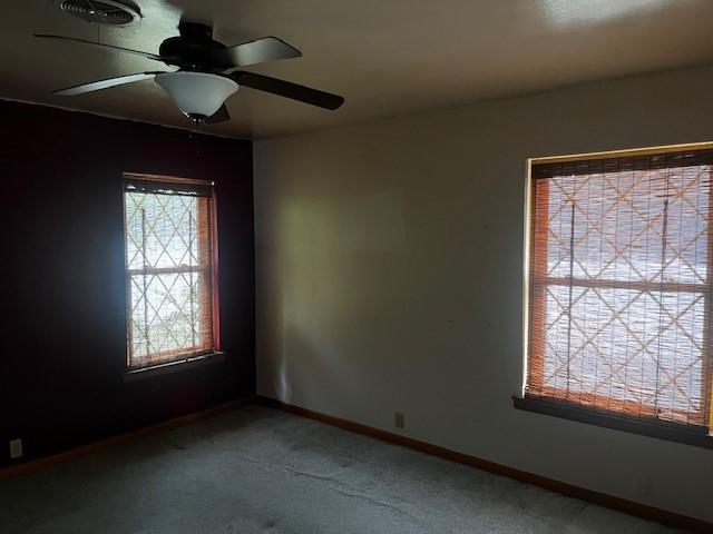 306 W Comanche St, Lindsay, OK 73052 - unfurnished room with ceiling fan, baseboards, and carpet floors